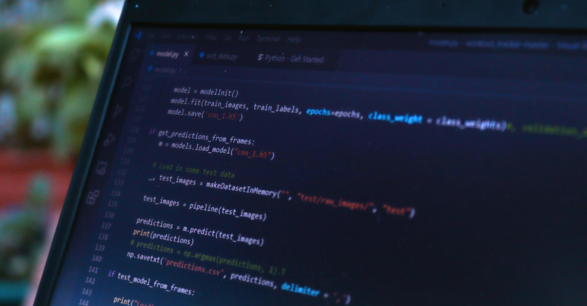 Dark laptop screen showing programming languages for cyber security in a terminal window