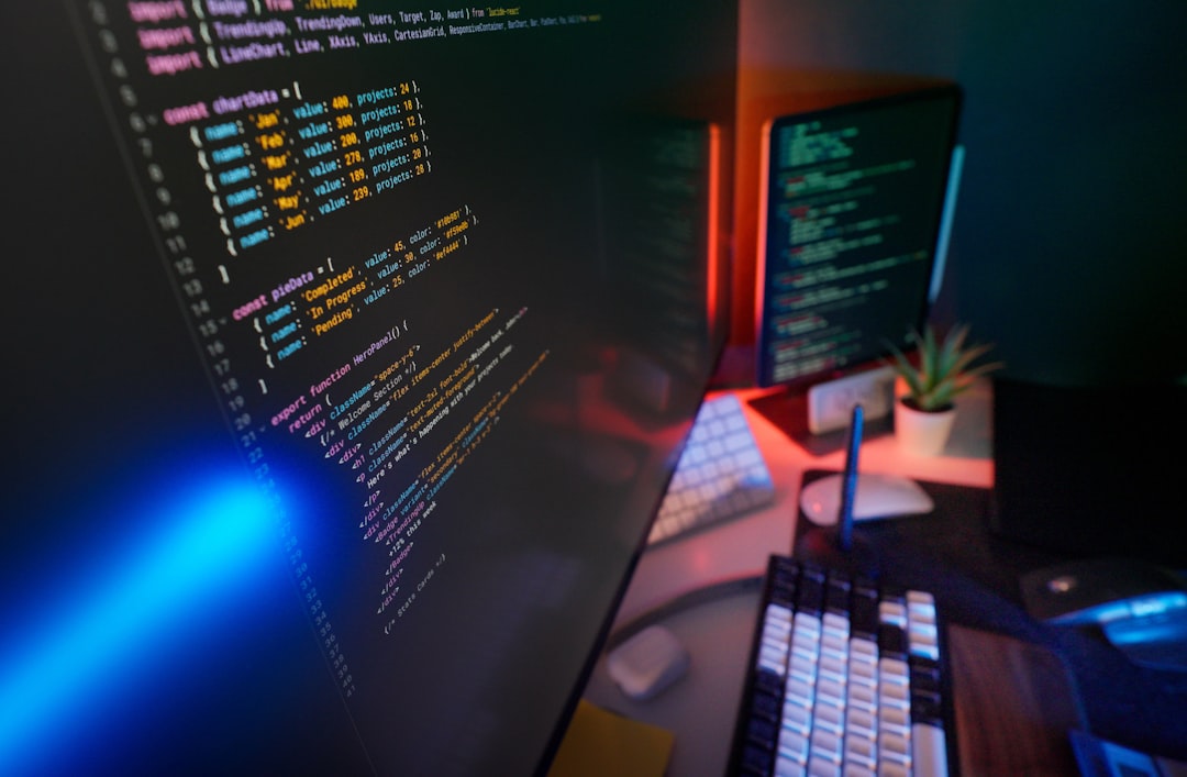 Dual monitor developer setup showing application code, representing a team patching against the Fastjson RCE vulnerability